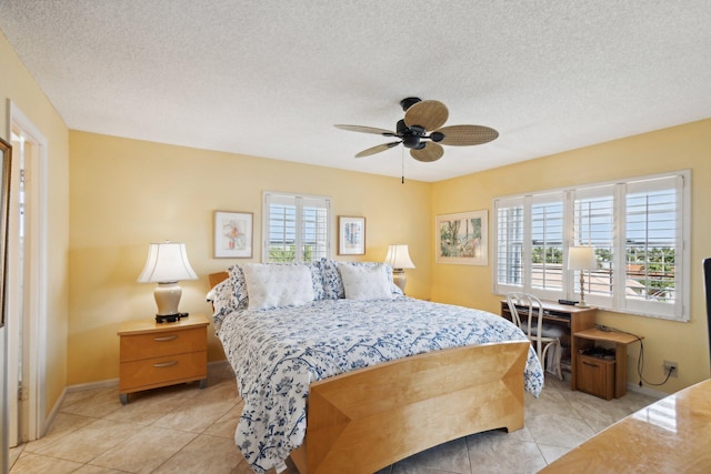 bedroom featuring multiple windows, light tile patterned floors, a textured ceiling, and ceiling fan