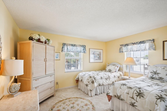 tiled bedroom featuring a textured ceiling