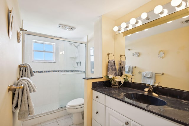 bathroom featuring tile patterned floors, vanity, toilet, and a shower with shower door