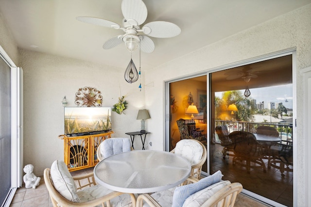 sunroom / solarium featuring ceiling fan