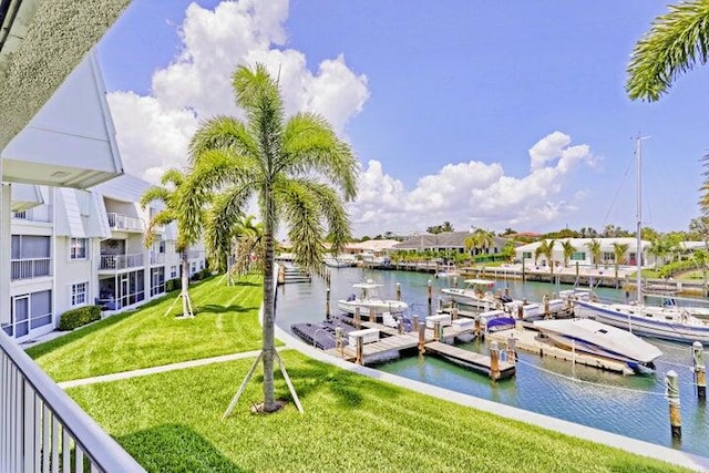 view of dock featuring a water view and a yard