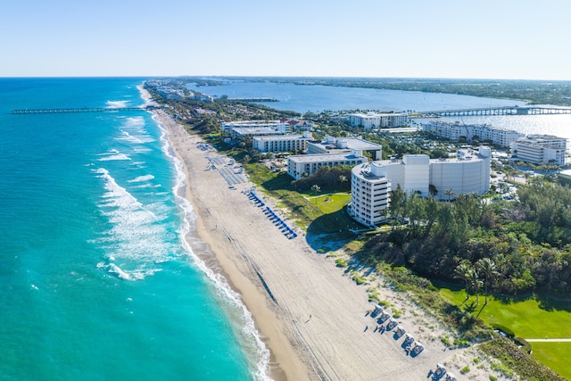 birds eye view of property with a water view and a view of the beach