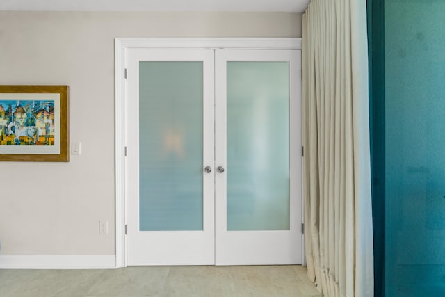 doorway to outside with french doors and light tile flooring