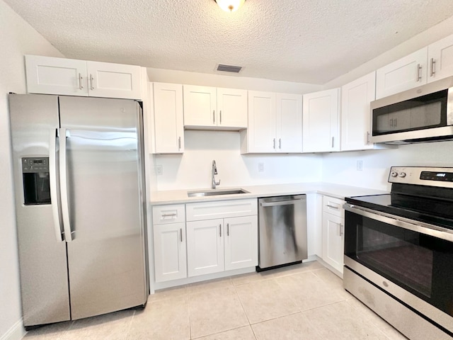 kitchen featuring sink, stainless steel appliances, and white cabinetry