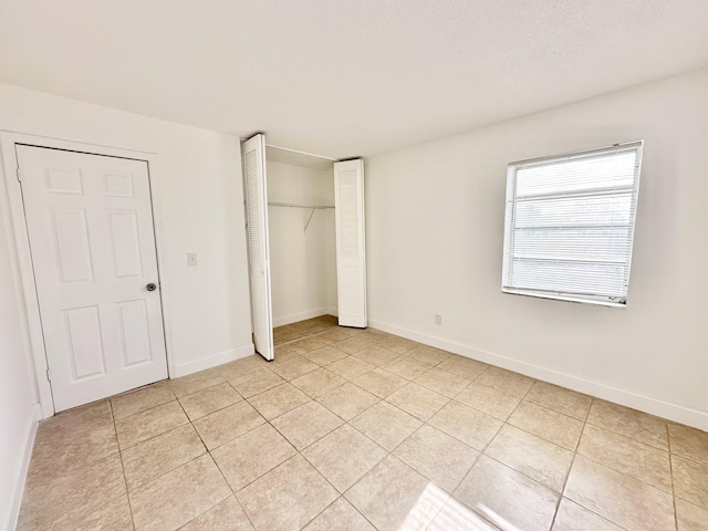 unfurnished bedroom with light tile floors