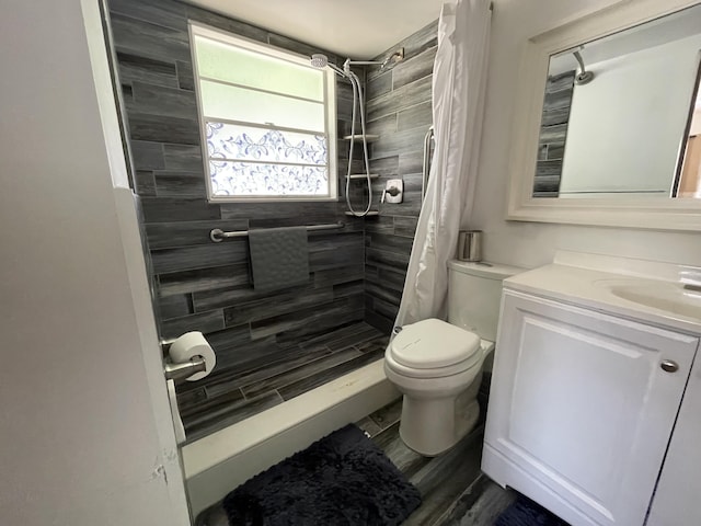 bathroom featuring curtained shower, vanity, wood-type flooring, and toilet