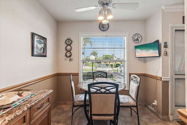 tiled dining space with ceiling fan