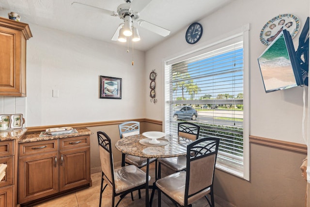 tiled dining room with ceiling fan