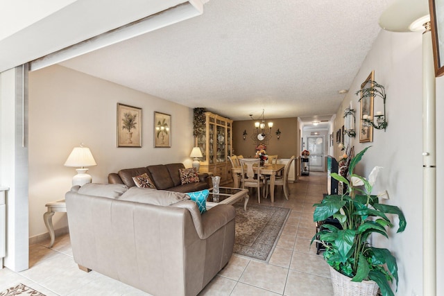 tiled living room with a notable chandelier and a textured ceiling