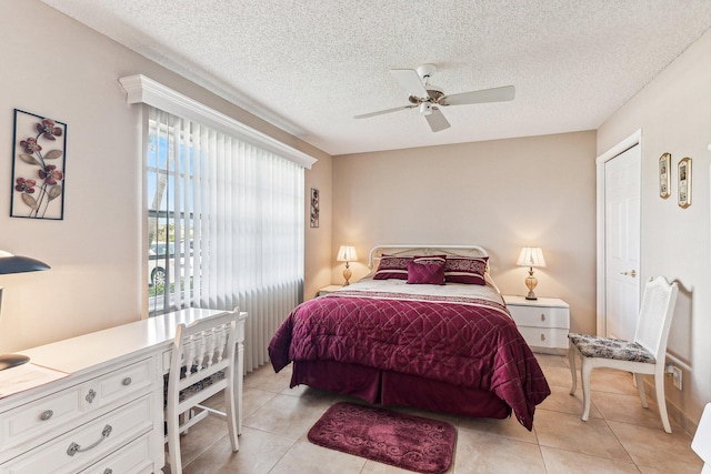 bedroom with ceiling fan, a textured ceiling, and light tile flooring