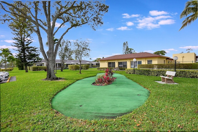 view of property's community with a yard