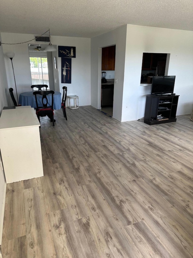 living room featuring a textured ceiling and wood finished floors