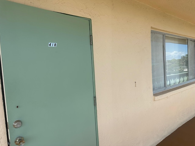 entrance to property with stucco siding