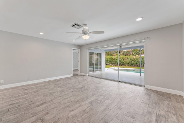 spare room featuring ceiling fan and light hardwood / wood-style floors