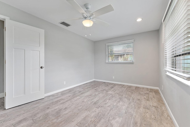 empty room with light wood-type flooring and ceiling fan