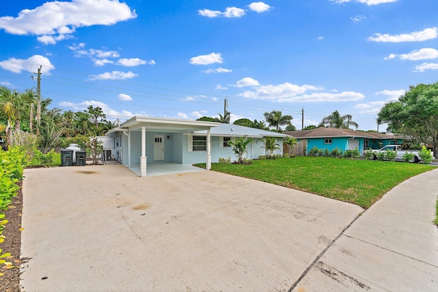 ranch-style home with a front yard and a carport