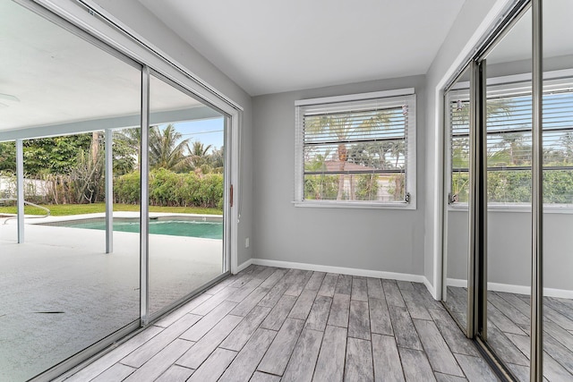 unfurnished sunroom featuring plenty of natural light