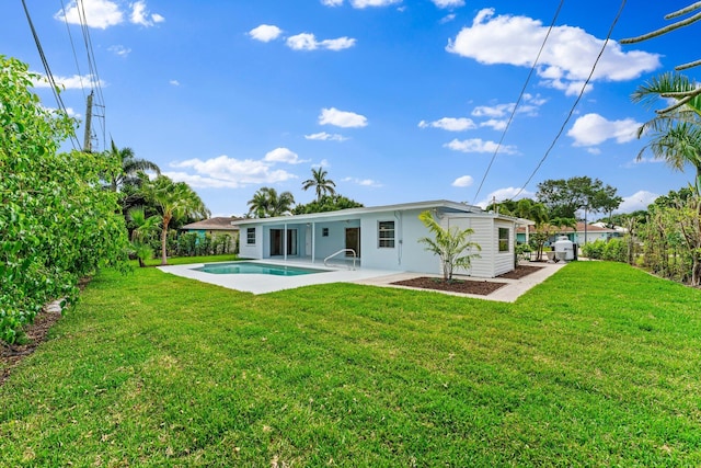 back of house with a yard and a patio