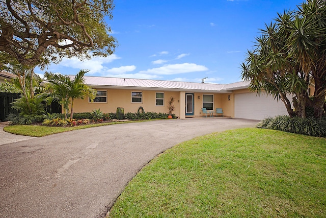 ranch-style home with a front yard and a garage