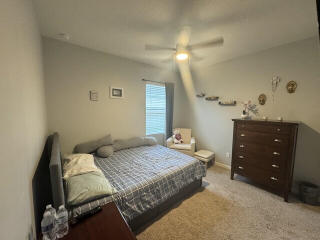 bedroom featuring light carpet and ceiling fan