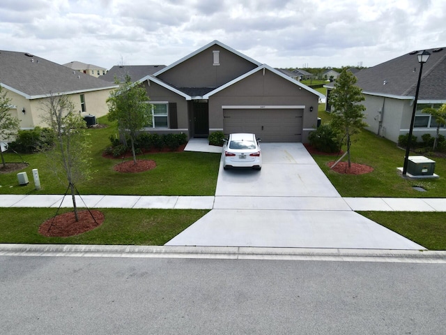 ranch-style home with a front yard, a garage, and central AC unit