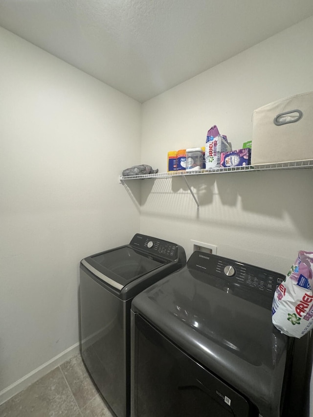 laundry area featuring hookup for a washing machine, washing machine and dryer, and light tile floors