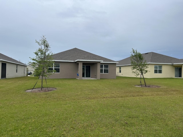 rear view of property with a lawn