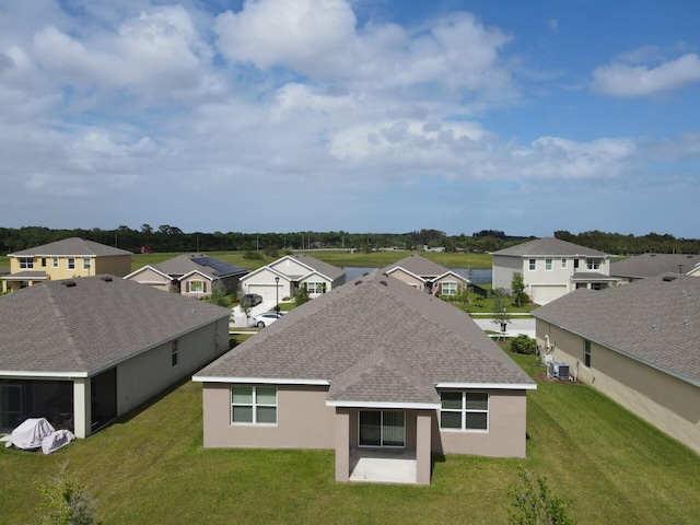 exterior space featuring a yard and central AC