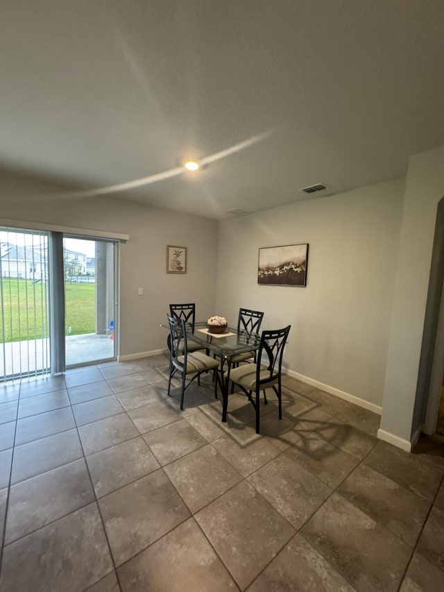 dining space featuring tile floors