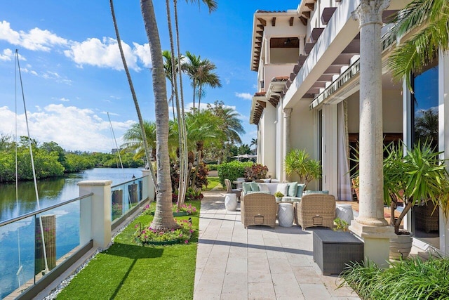 view of patio / terrace with a balcony, an outdoor hangout area, and a water view