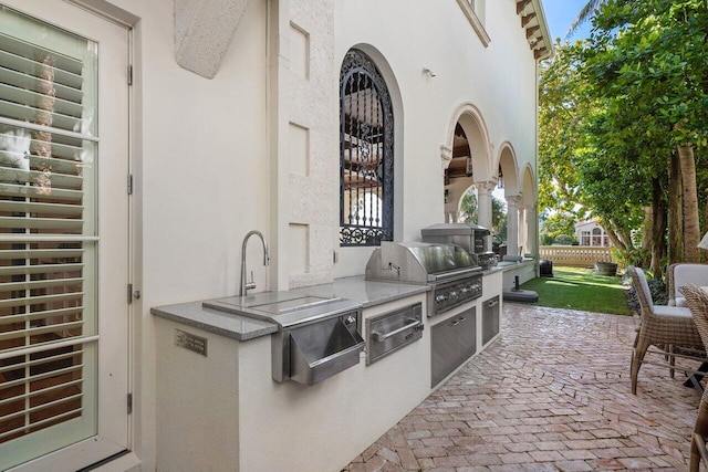 view of patio with a grill and exterior kitchen