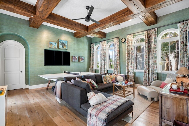 living room with coffered ceiling, light hardwood / wood-style floors, beam ceiling, ceiling fan, and a wealth of natural light