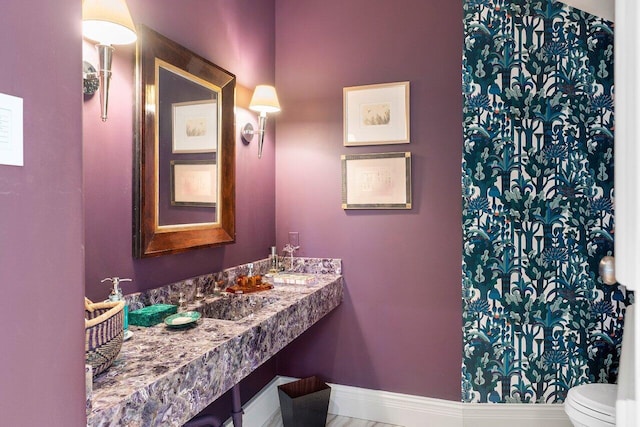 bathroom featuring toilet and vanity