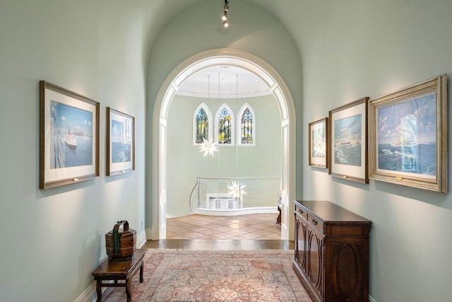 tiled entrance foyer with an inviting chandelier