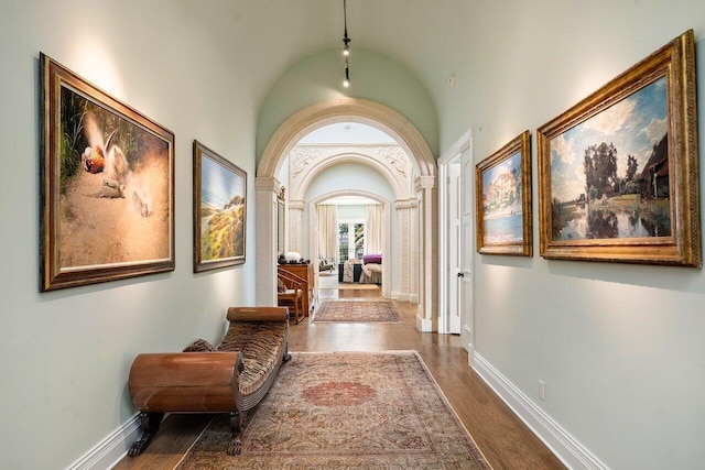 hallway featuring lofted ceiling and dark wood-type flooring