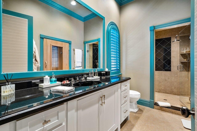 bathroom featuring an enclosed shower, vanity, tile flooring, toilet, and ornamental molding