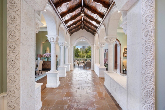 tiled foyer featuring wood ceiling and ornate columns