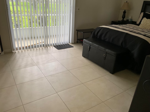 bedroom with access to outside and light tile flooring