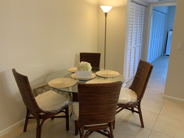 dining area featuring light tile floors