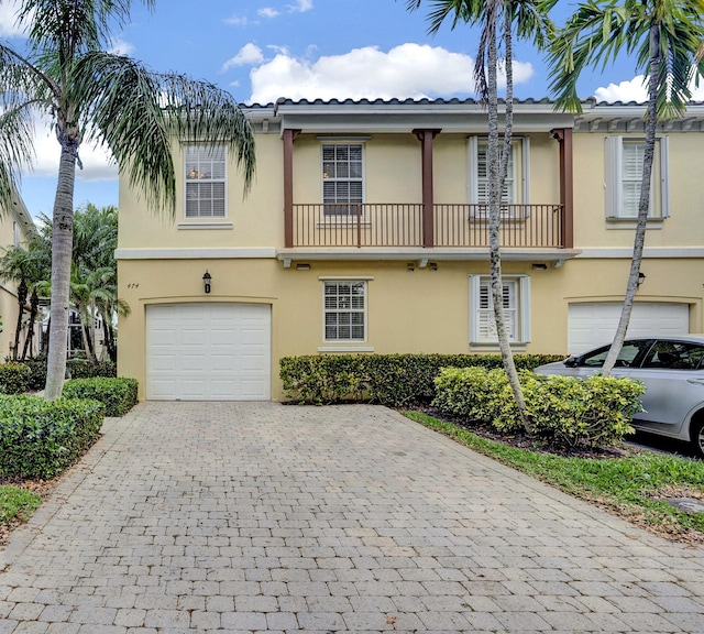 view of front of property with a balcony and a garage