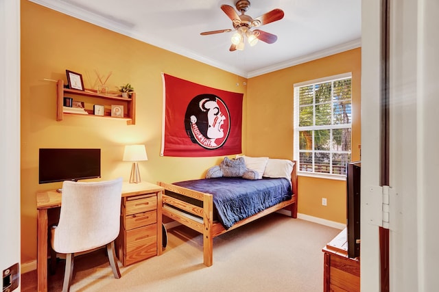 carpeted bedroom featuring ceiling fan and ornamental molding