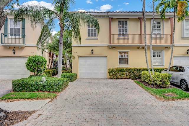 view of front of property with a balcony and a garage