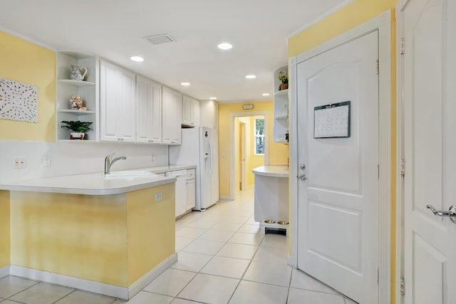 kitchen with white cabinets and light tile flooring