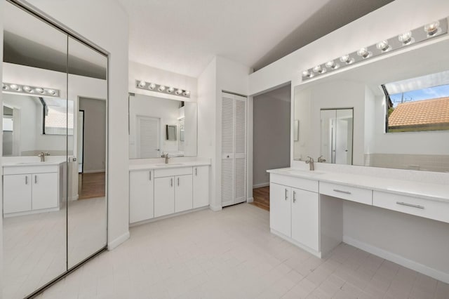 bathroom with tile floors and dual vanity