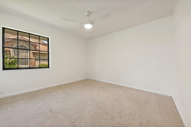 spare room with carpet and ceiling fan