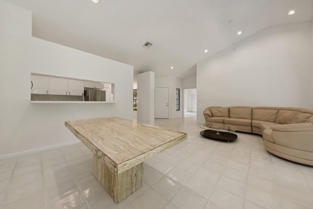 living room featuring high vaulted ceiling and light tile flooring