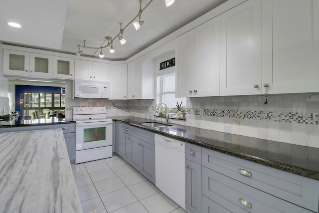 kitchen with white cabinets, white appliances, dark stone countertops, and sink