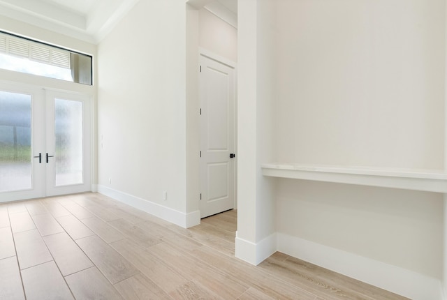 foyer entrance featuring light wood-type flooring and french doors