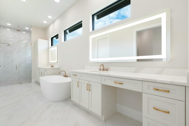 bathroom with vanity, a healthy amount of sunlight, and plus walk in shower