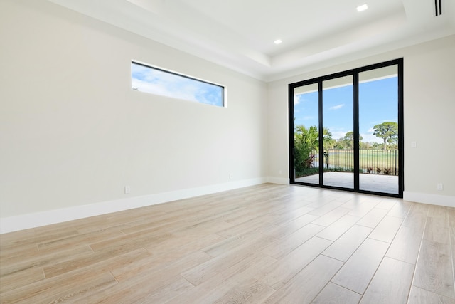 empty room featuring a raised ceiling